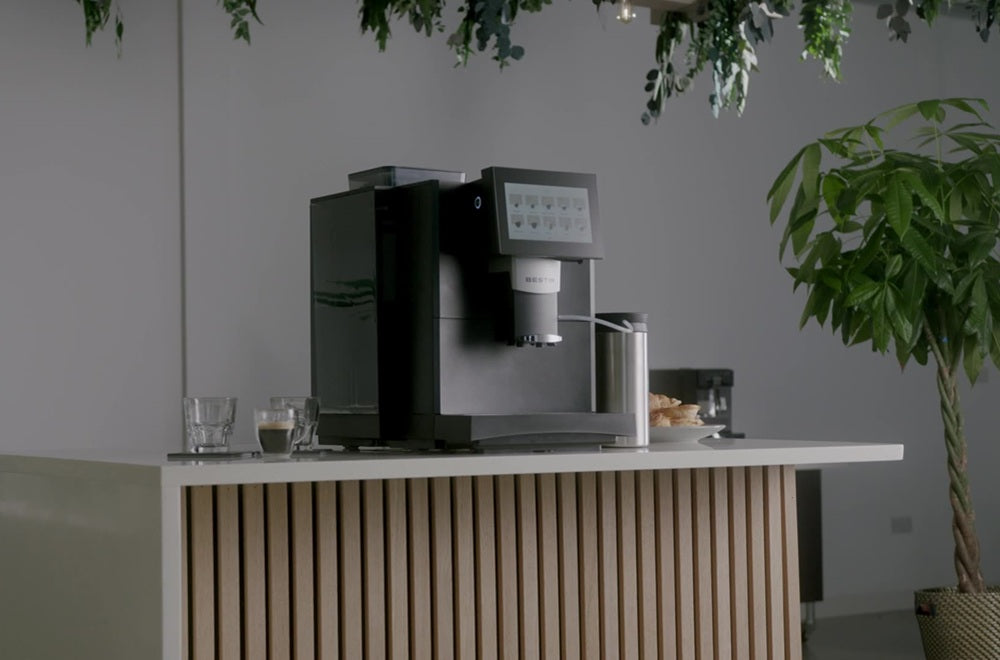 Bestir BM40 commercial automatic coffee machine displayed on a modern wooden slat counter in an office breakroom setting.