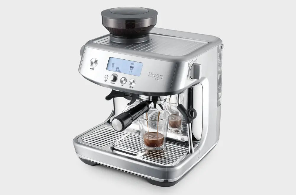 The Sage Barista Pro actively pouring a rich double espresso shot into glass cups.