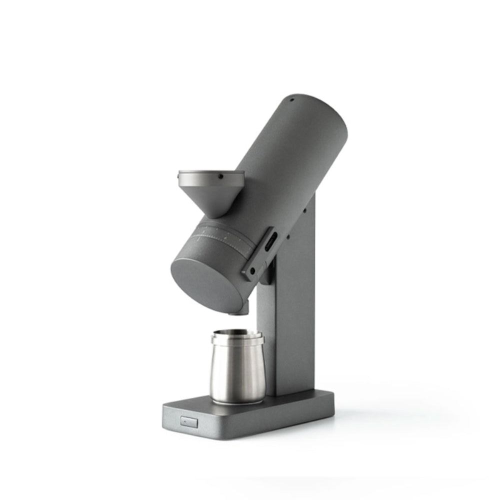 Angled view of the Acaia Orbit Coffee Grinder SSP with a stainless steel cup placed below the grinder chute.