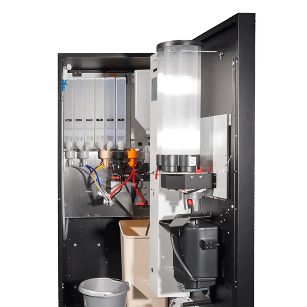 Interior view of the Coffetek Neo vending machine showing the cup stacker, waste bin, and large capacity ingredient canisters for milk, sugar, and tea.