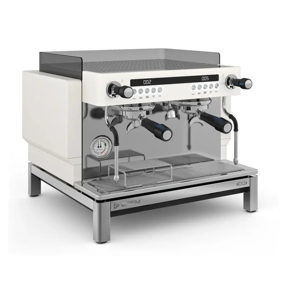 Front angled view of CREM EX3 2 group compact mini espresso machine in white with dual portafilters and steam wand