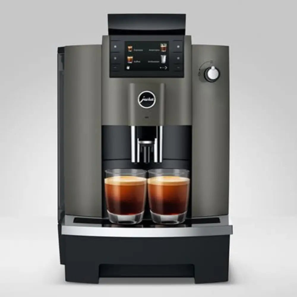 Jura W4 automatic coffee machine front view, dispensing two espresso drinks.