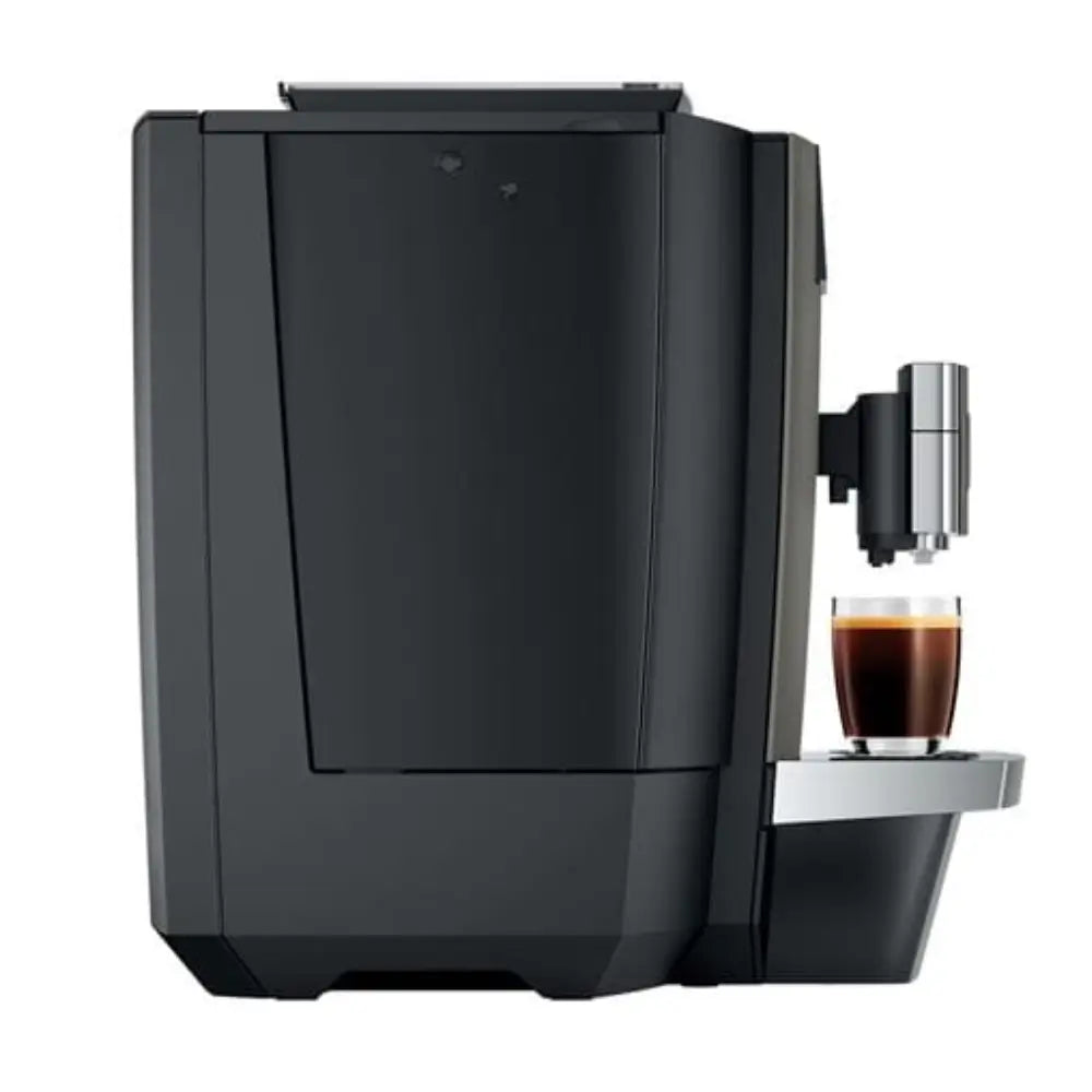 Side view of Jura X10c bean-to-cup coffee machine brewing an espresso.