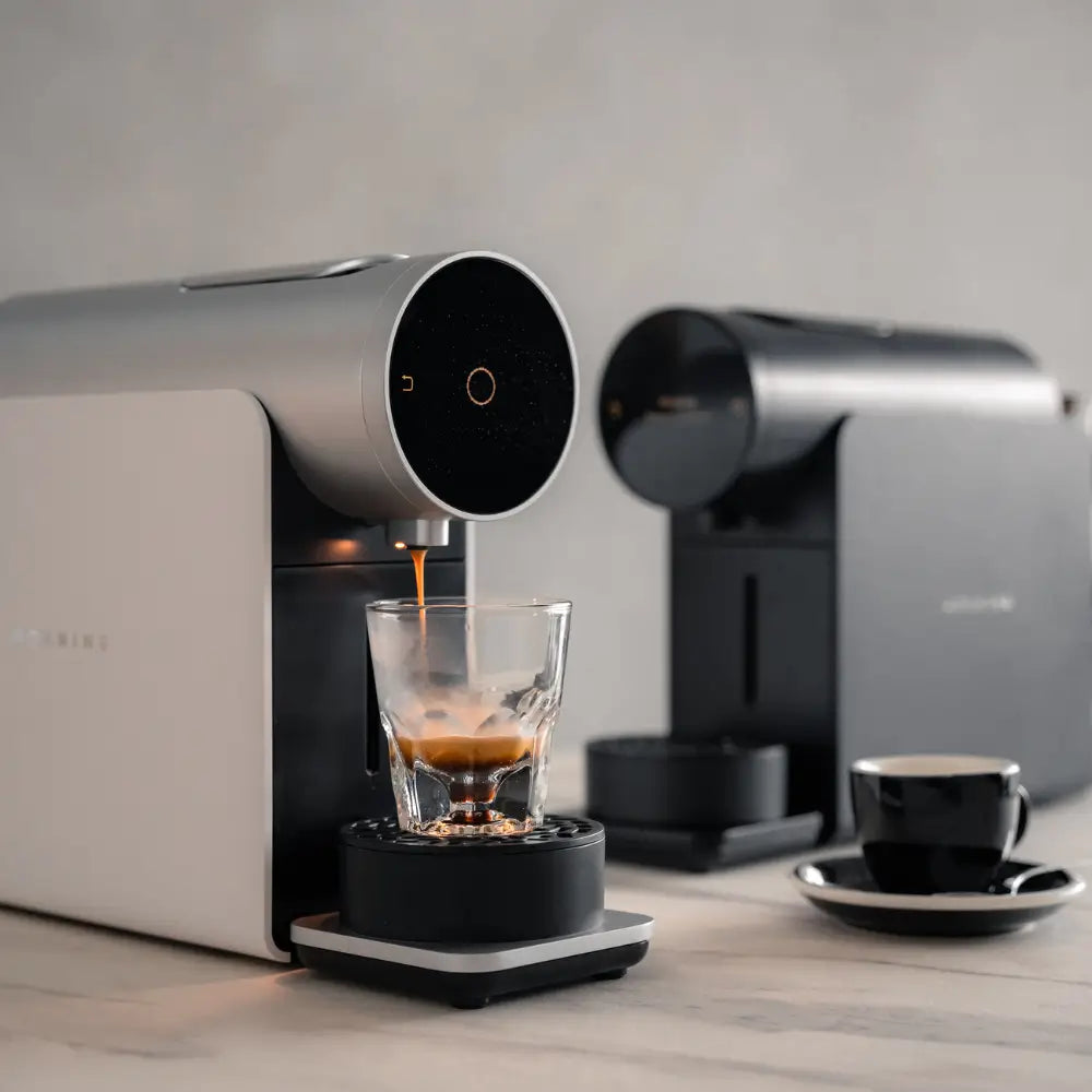 Angled Side view of Morning Coffee Machine 220v in black finish on a wooden table with glass cup.