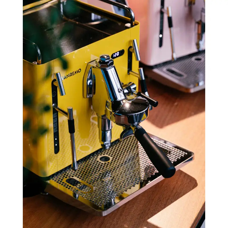 Close-up of the Sanremo Cube R in gloss yellow, showing the E61 grouphead and digital temperature display.