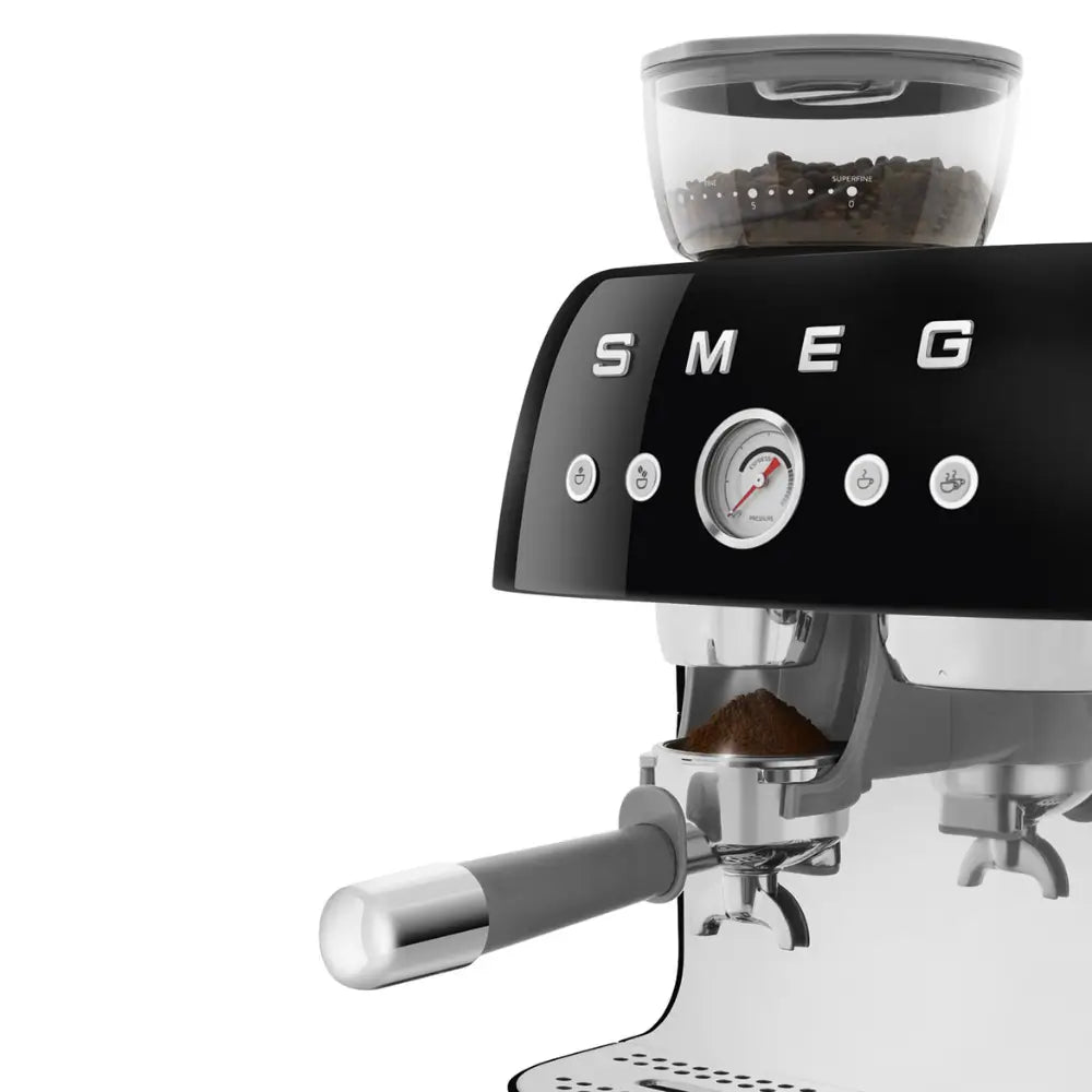 Close-up of the integrated grinder dispensing coffee into the portafilter on the SMEG EGF03.
