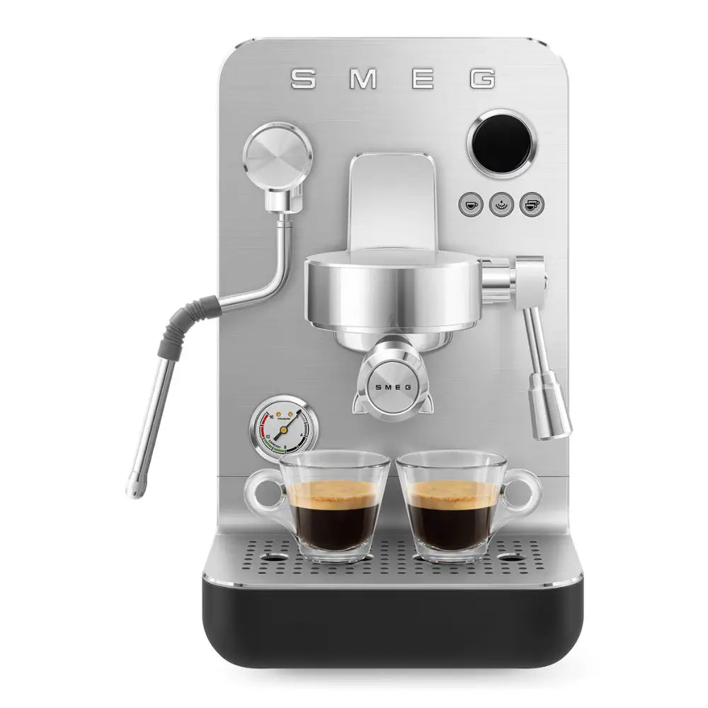 Front view of the SMEG Minipro actively brewing two shots of espresso into glass cups.