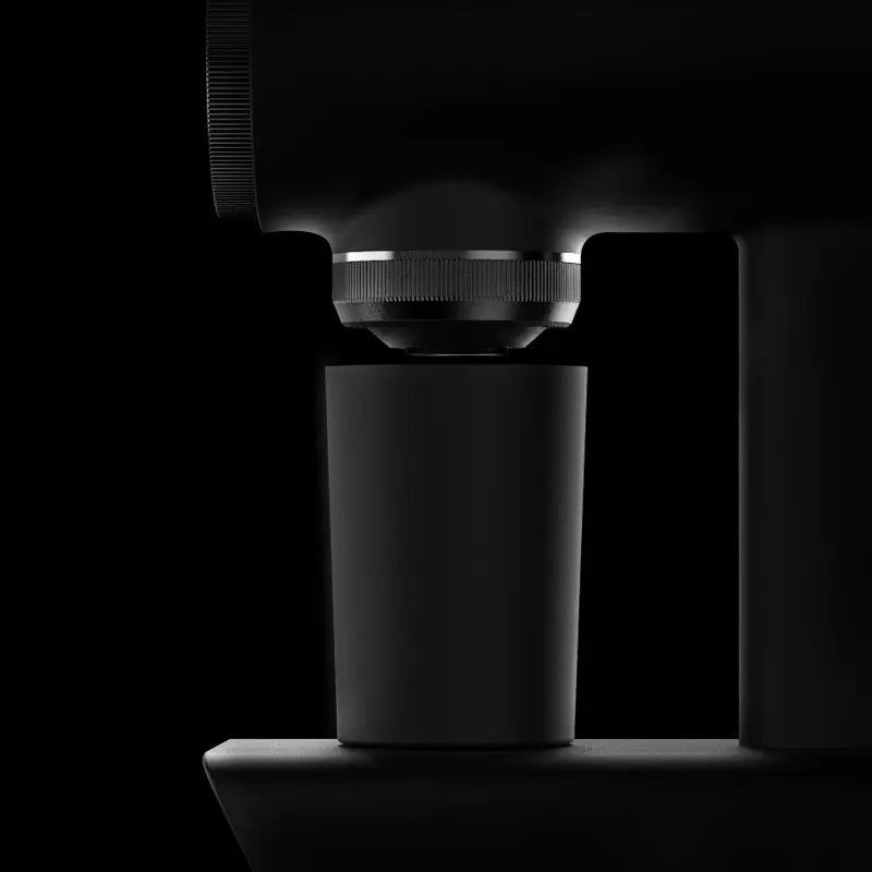Close-up of Timemore Sculptor 064S coffee grinder with magnetic catch cup.