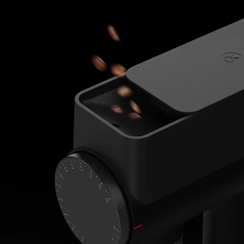 Timemore Sculptor 064S coffee grinder with beans falling into hopper.