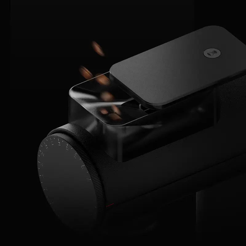 Timemore Sculptor 078S coffee grinder with beans falling into hopper.