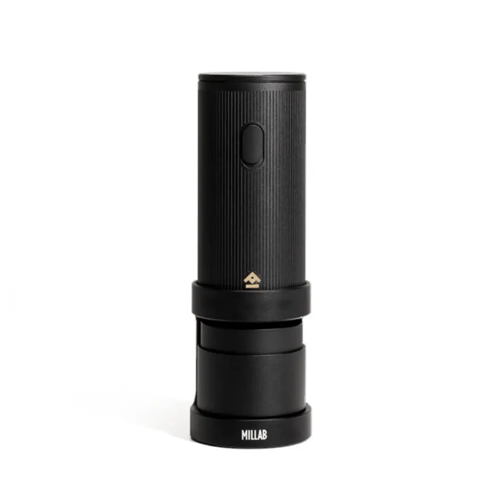 The black edition of the Timemore x Millab electric coffee grinder resting on its dedicated charging base, highlighting the minimalist aluminum body and wireless portable design.