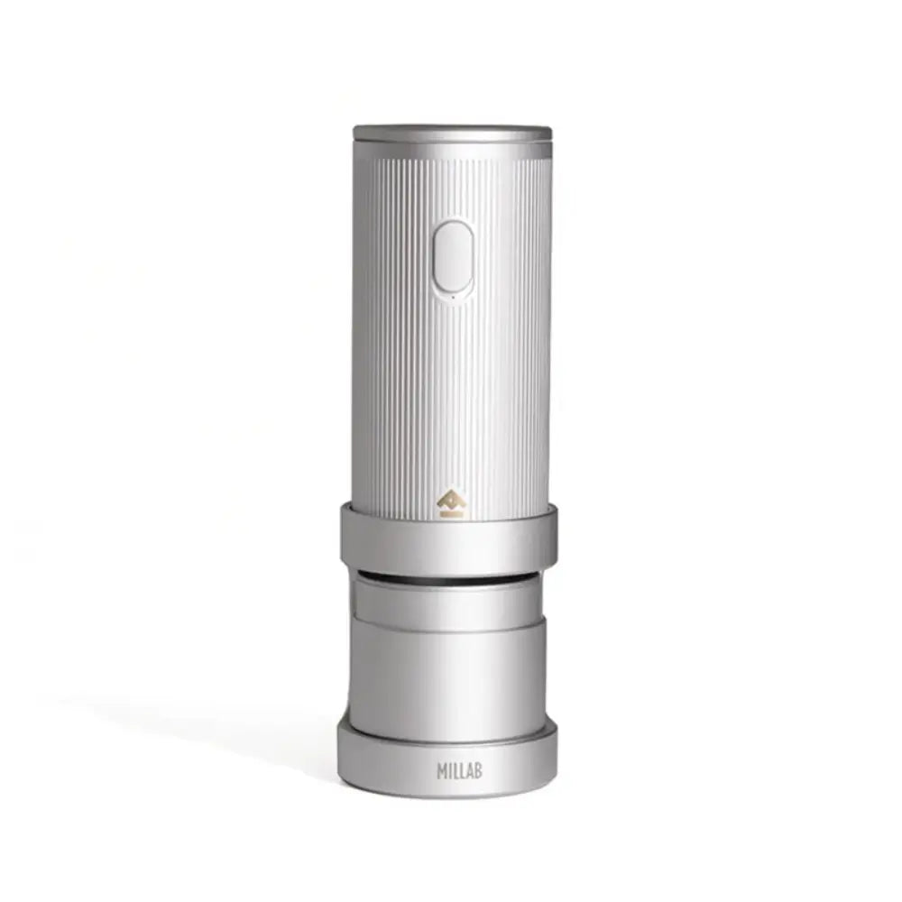 The silver edition of the Timemore x Millab electric coffee grinder resting on its dedicated charging base, highlighting the minimalist aluminum body and wireless portable design.