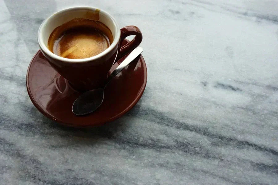 Espresso cup on a marble cafe counter - commercial coffee machine leasing guide