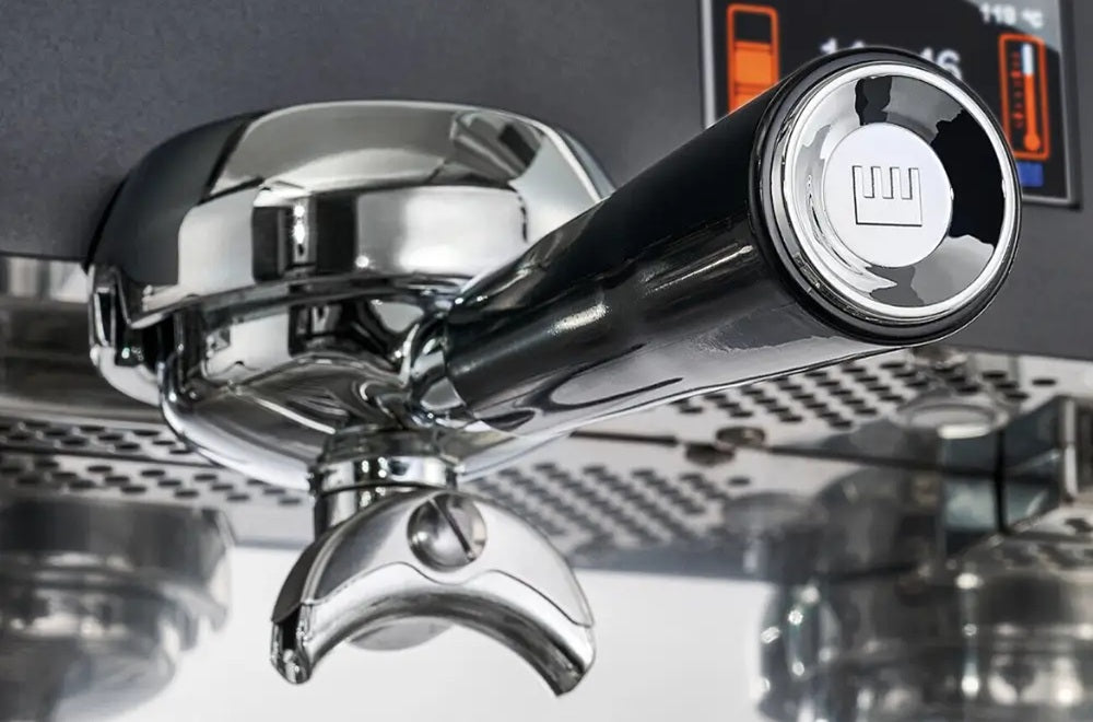 Close-up detail of the La Pavoni Professional Expo manual lever machine featuring the iconic gold eagle topper and pressure gauge.