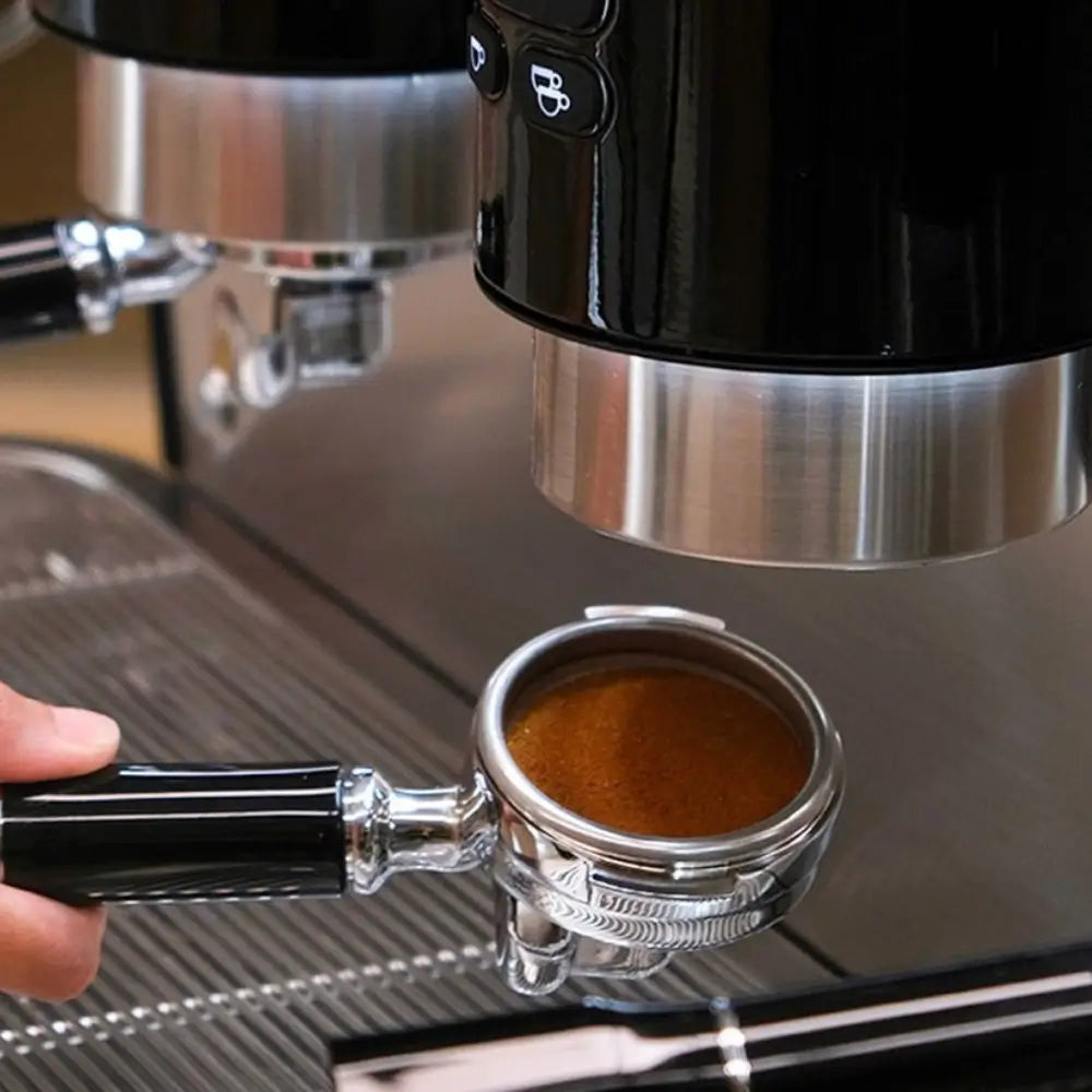 Hand holding a portafilter filled with freshly extracted espresso and rich crema, beneath the group head of the Iberital Vista.