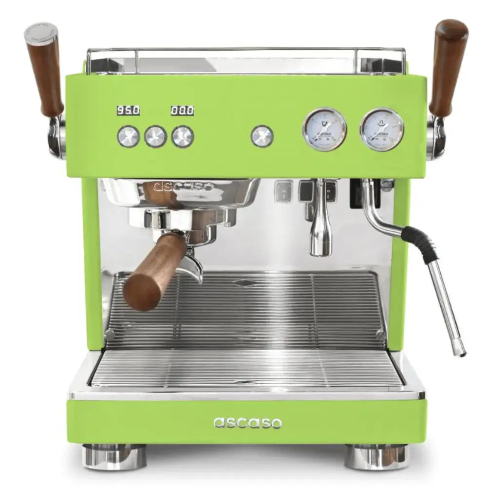 Front view of the Ascaso Baby T Plus espresso machine in green with wooden handles, dual gauges, and polished metal finish, ideal for professional coffee setups.