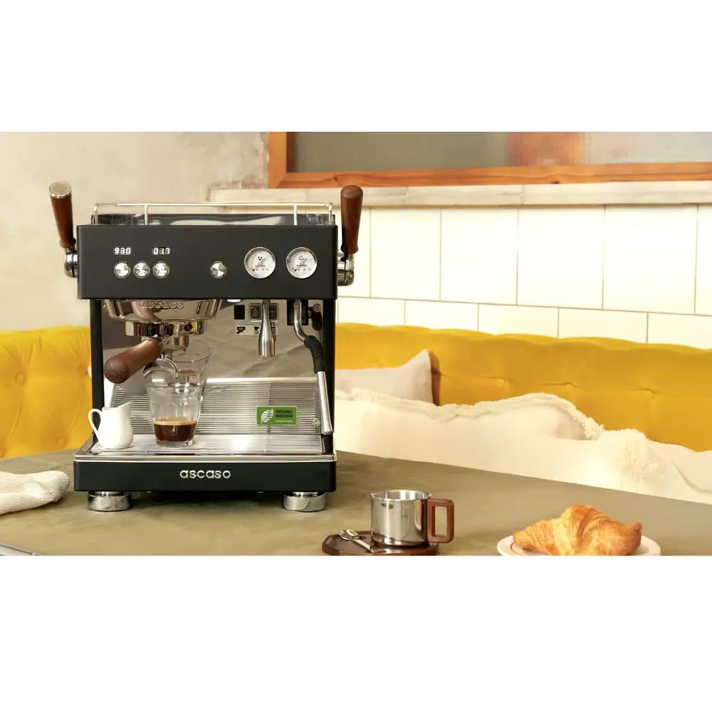 Ascaso Baby T Plus espresso machine on a café counter showcasing its stylish and compact design.