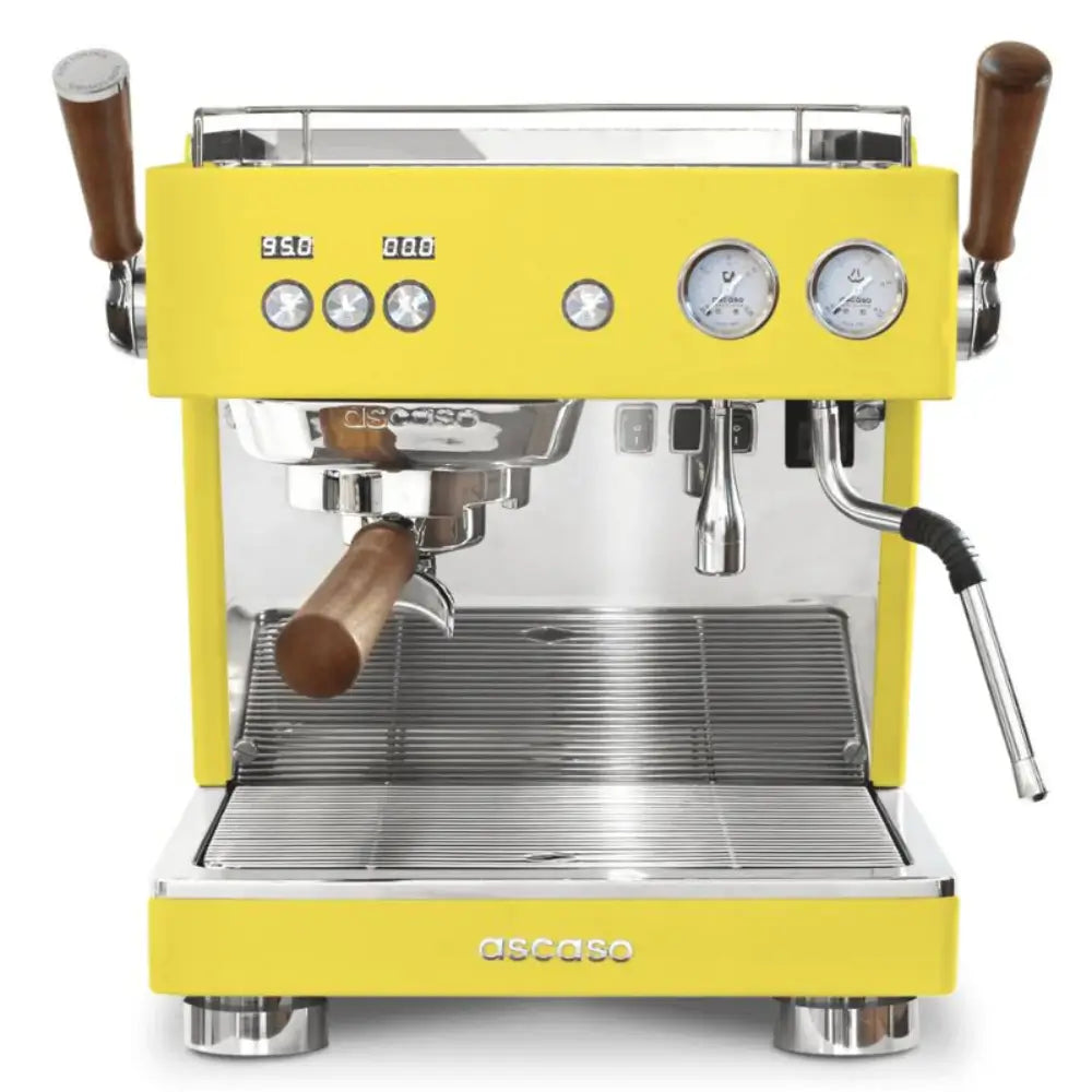 Front view of the Ascaso Baby T Plus espresso machine in yellow with wooden handles, dual gauges, and polished metal finish, ideal for professional coffee setups.
