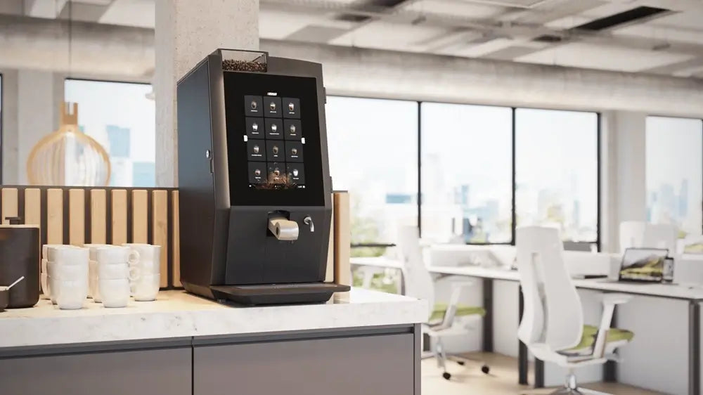 Angled view of the Bravilor Esprecious 11 bean-to-cup espresso machine on a marble counter in a modern office