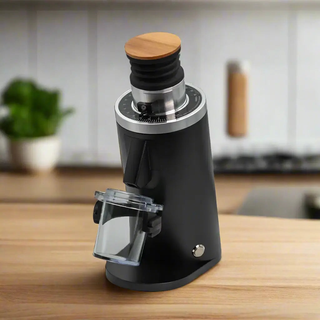 Angled view of DF54 electric coffee grinder in black on a wooden kitchen counter top