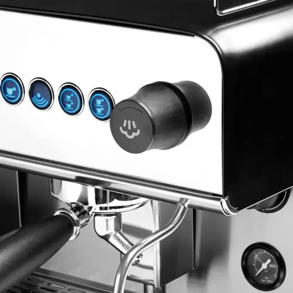 Close-up view of the Iberital IB7's chrome control panel, showing the backlit brewing buttons and the steam wand knob.