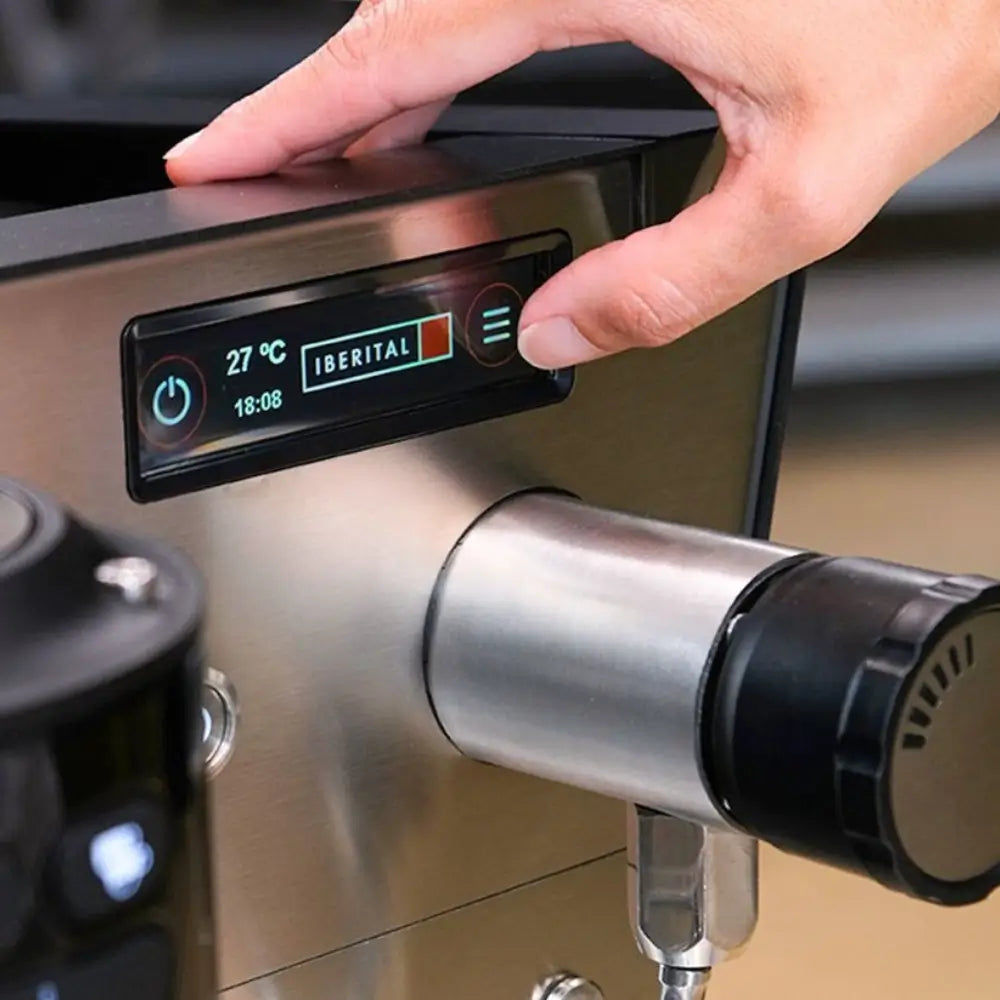 Close-up of a hand interacting with the Iberital Vista's digital screen, showing temperature, time, and menu settings.