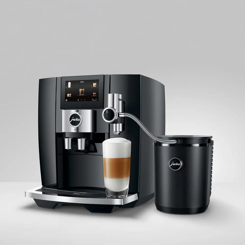 Jura Cool Control milk container connected to a Jura automatic coffee machine (likely E8/J8) making a latte macchiato.