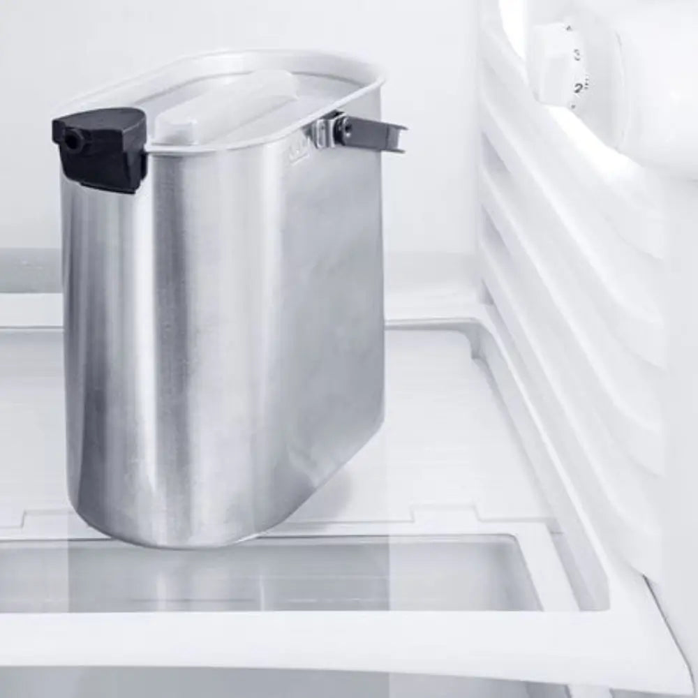 Close-up of the Jura Cool Control stainless steel milk container insert stored inside a refrigerator.