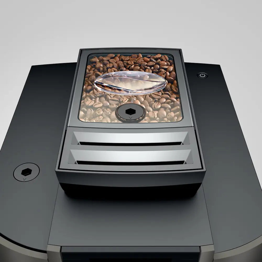 Top-down view of the Jura W4 bean hopper filled with whole coffee beans.