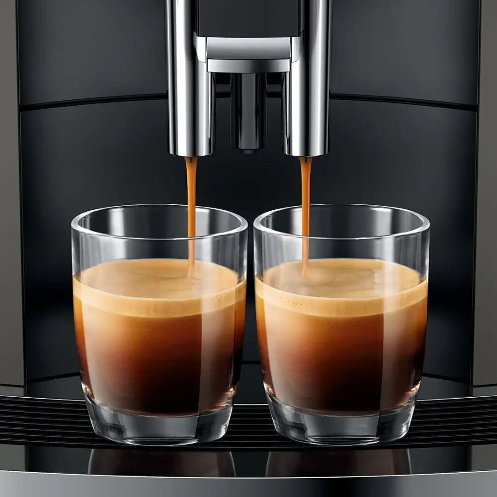 Close-up of Jura W4 dispensing two shots of espresso with rich crema.