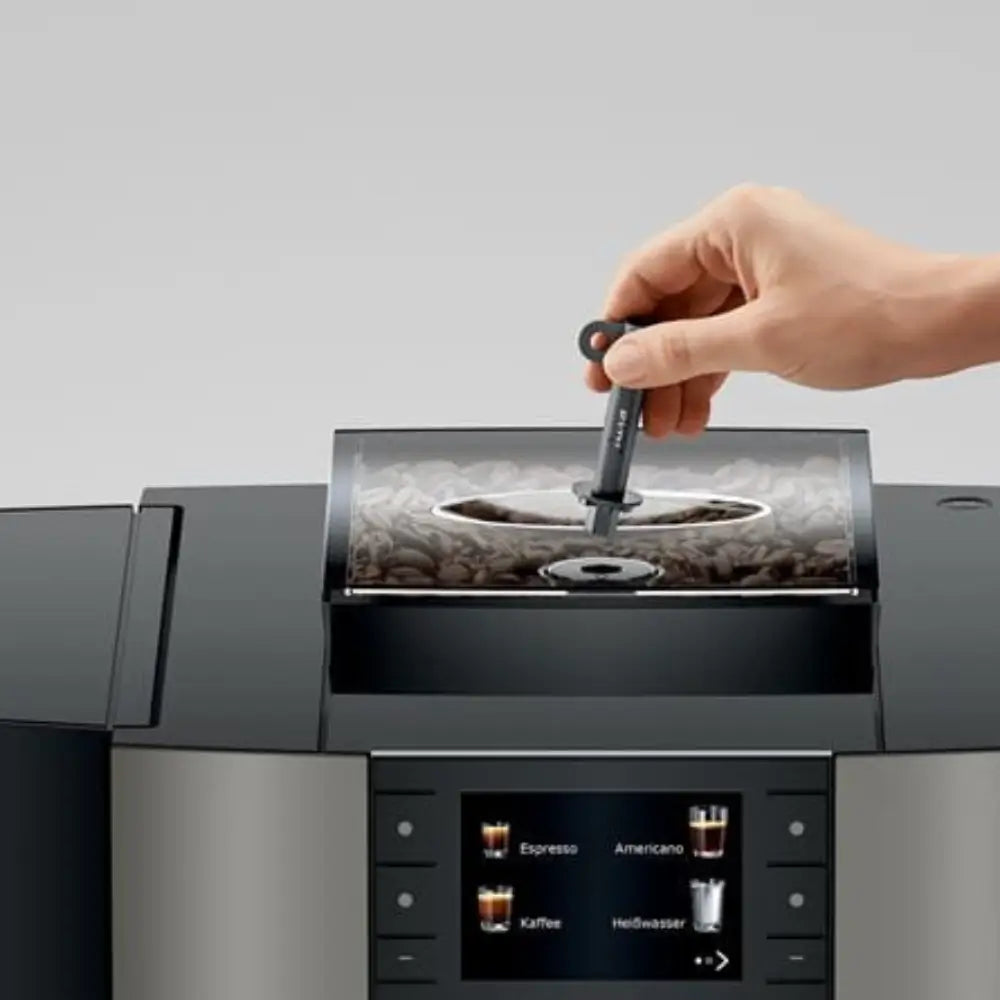 Hand adjusting the coffee bean hopper on the Jura X4 bean-to-cup coffee machine.