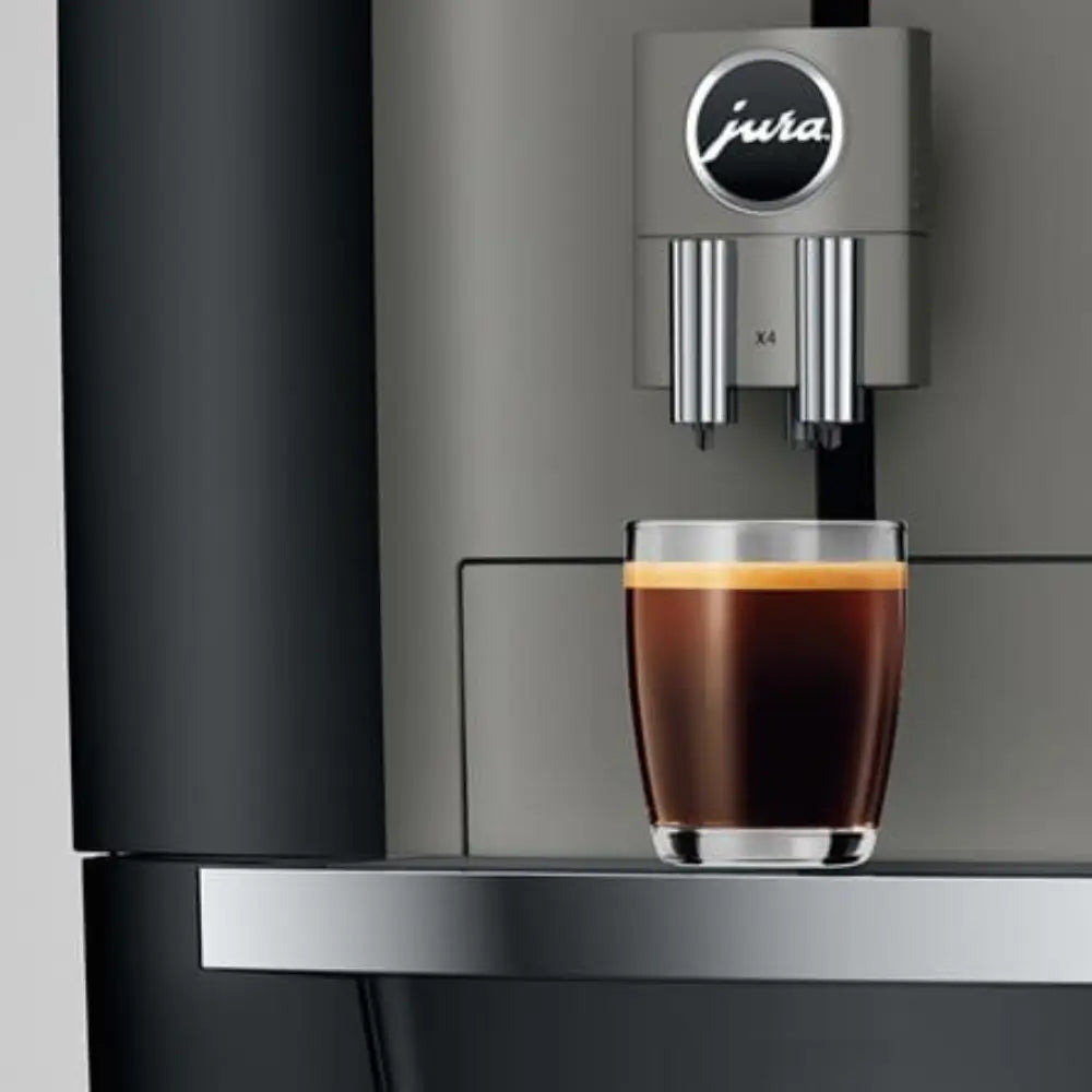 Close-up of the Jura X4 coffee spout dispensing a freshly brewed coffee.