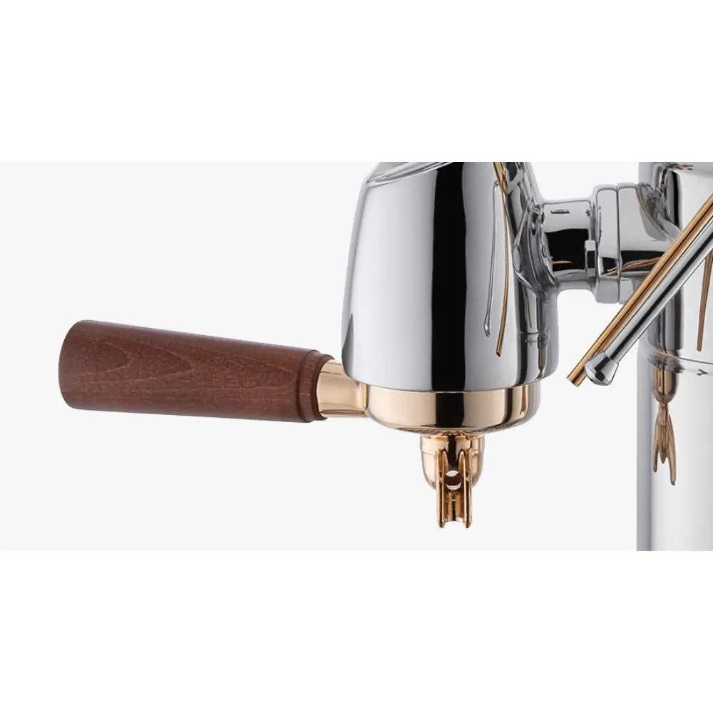 A close-up of the La Pavoni Expo's brew group and portafilter with a wooden handle.