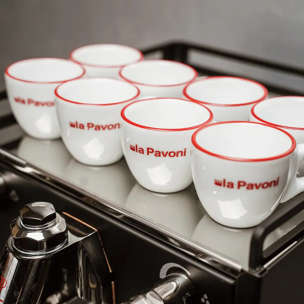 Close-up of multiple La Pavoni espresso cups warming on the top cup tray of the Cellini Classic.