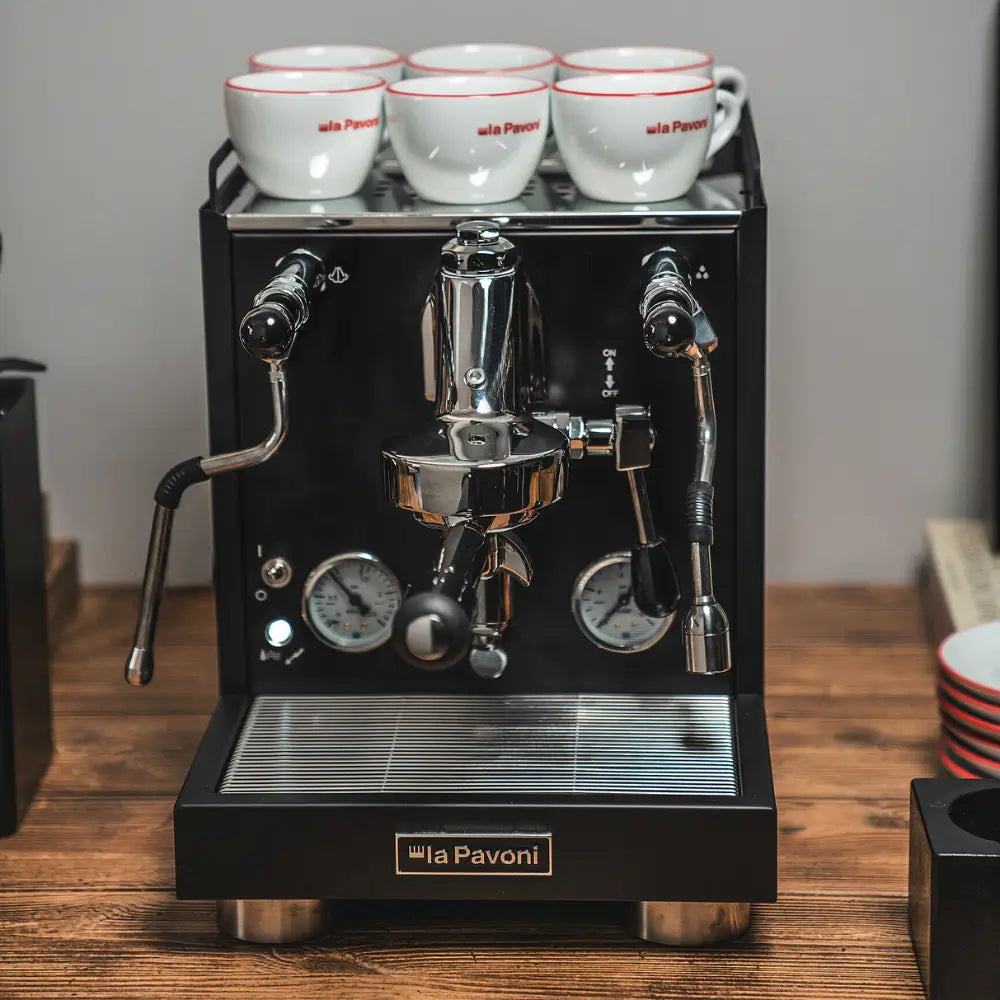 Front view of the La Pavoni Cellini Evolution espresso machine in matte black with espresso cups on the warming tray.