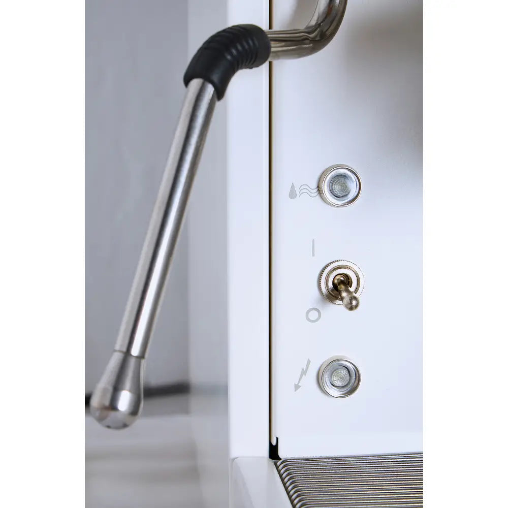Detailed view of the steam wand and toggle control switches on the white La Pavoni Cellini Evolution.