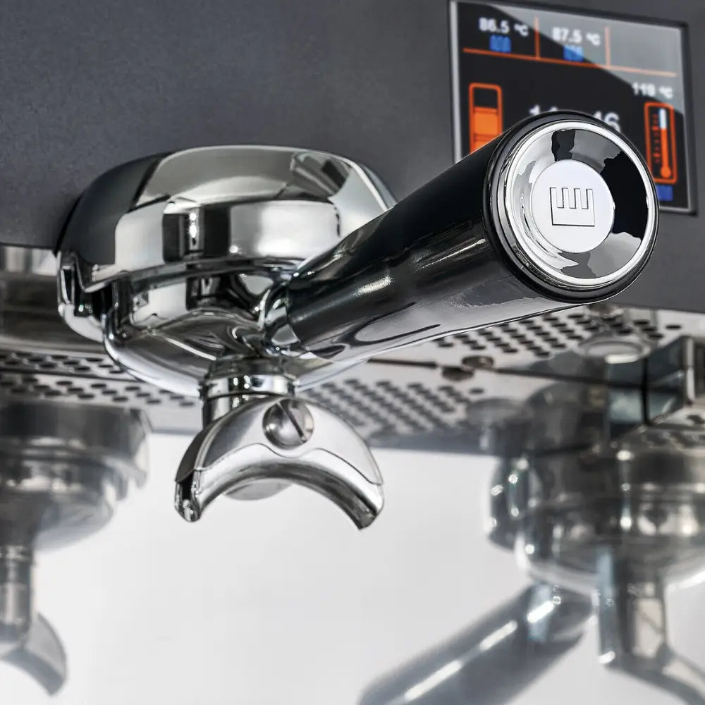 A close-up of the polished chrome portafilter and handle on the La Pavoni Desiderio.