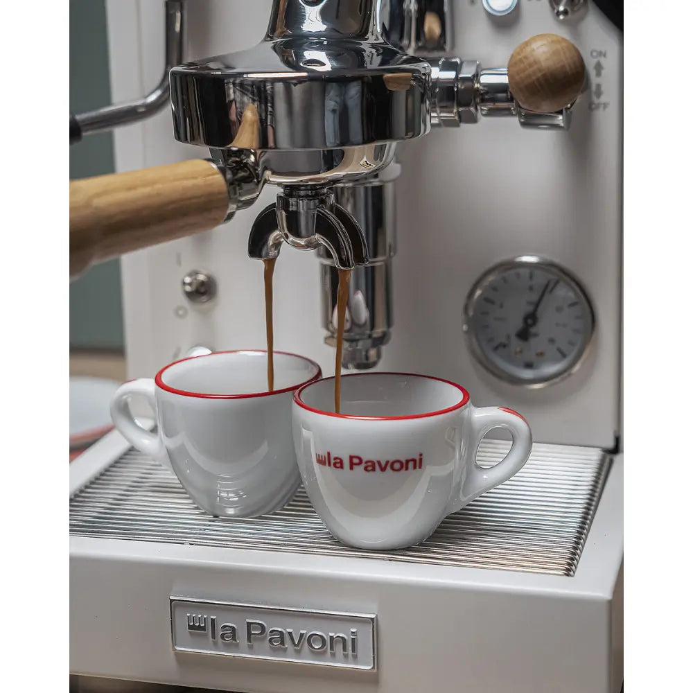 Close-up of espresso extraction with two streams of coffee pouring into cups from the La Pavoni Mini Cellini.