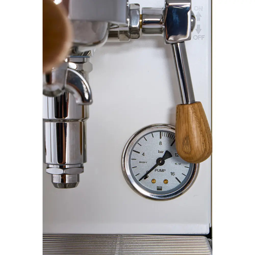 Close-up of the pump pressure gauge and wooden brew lever on the white La Pavoni Mini Cellini.