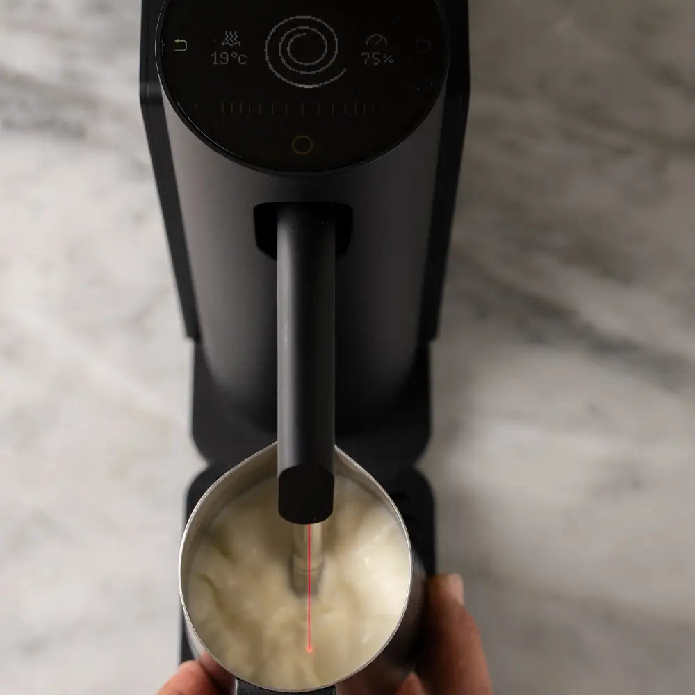 Top view of the Morning Dream Milk Steamer showing the steam wand in action.