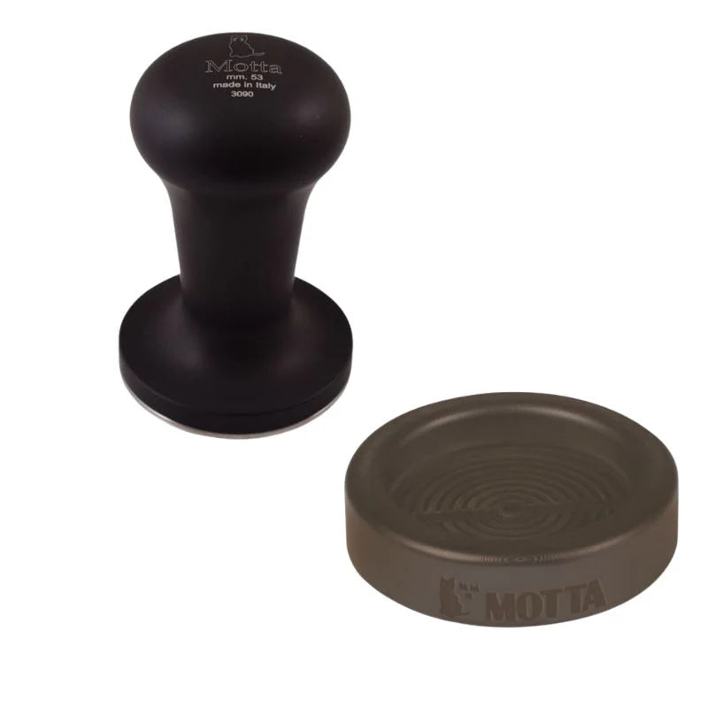 Front view of the black Motta Flash coffee tamper with matching rubber holder
