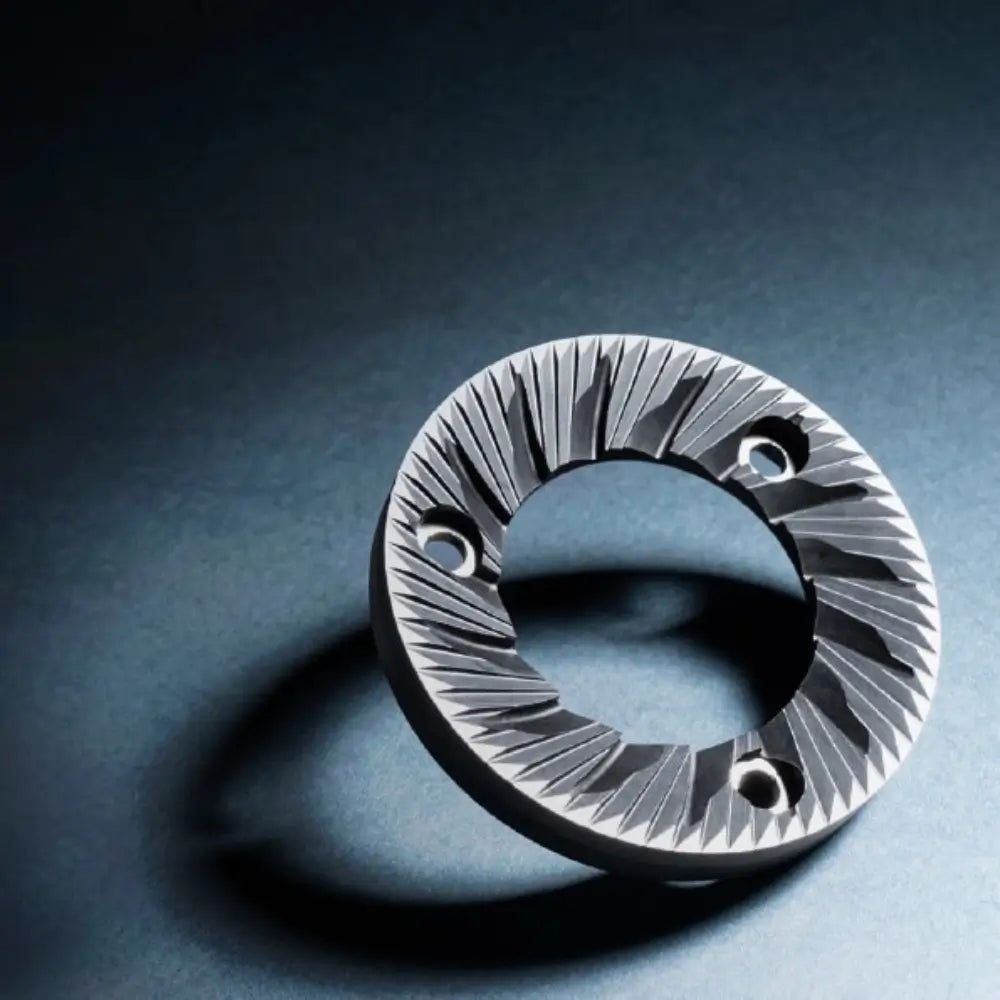 Detailed close-up of the large, professional 83mm flat steel burr used in the Sanremo SR83 E Pro grinder.