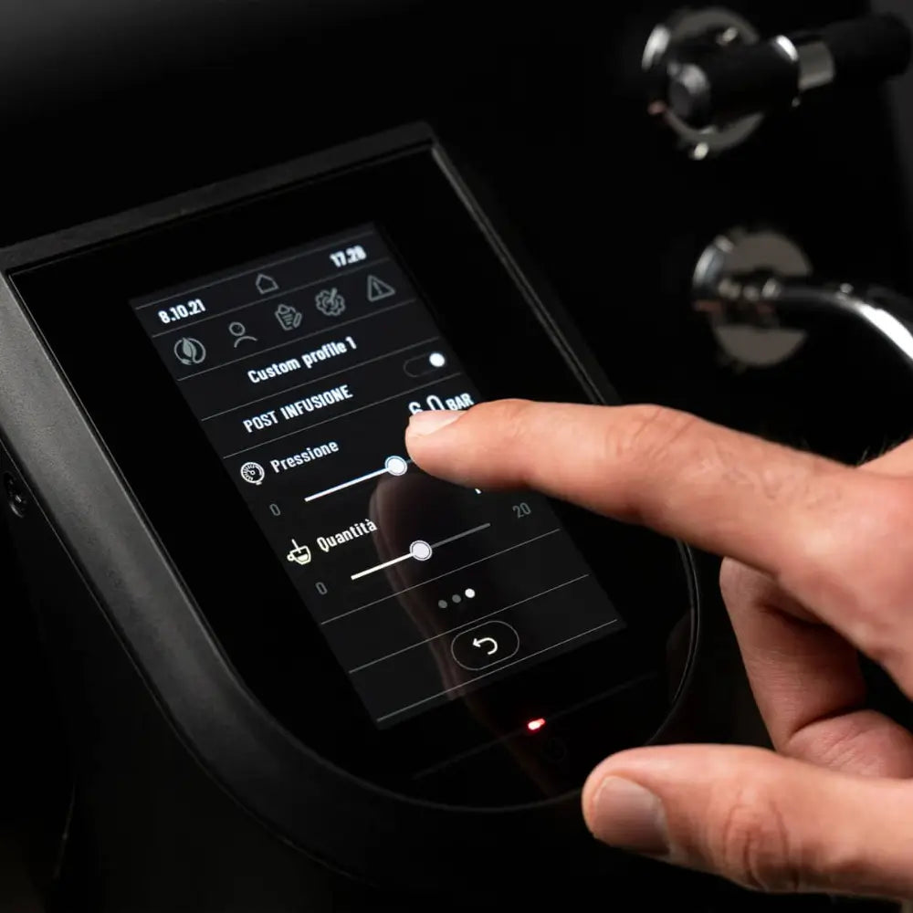 A hand adjusting the post infusion pressure and quantity settings on the Sanremo YOU's pressure profiling screen.