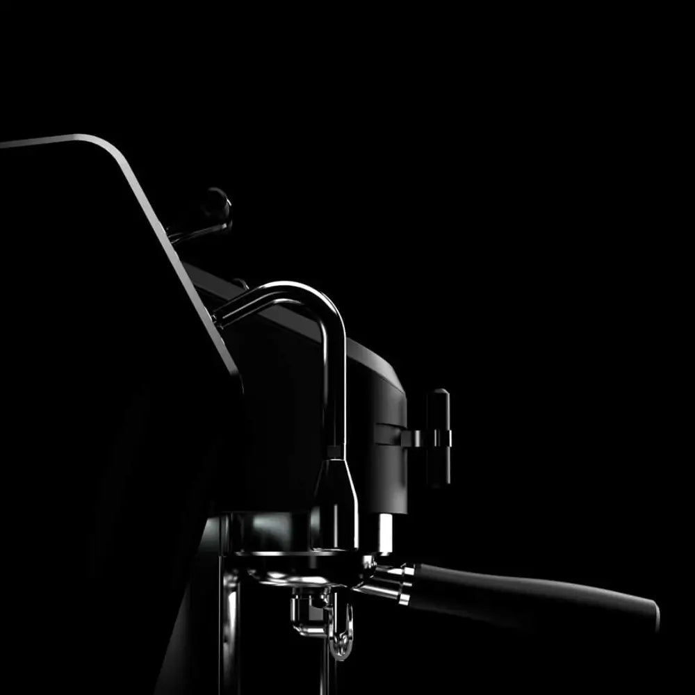 Artistic close-up of the chrome steam wand and portafilter detail on the Sanremo YOU espresso machine.