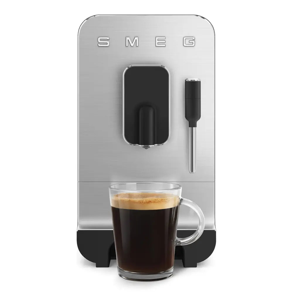 The SMEG BCC12 bean-to-cup machine dispensing a long coffee into a clear glass mug.